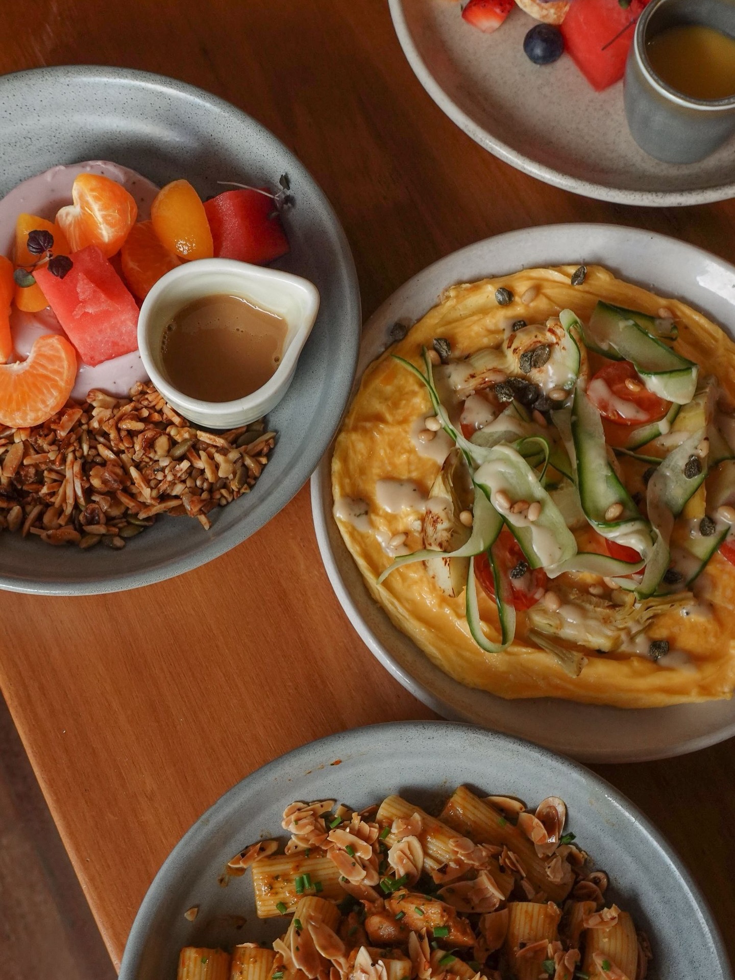 Brunch spread with omelette, granola and rigatoni